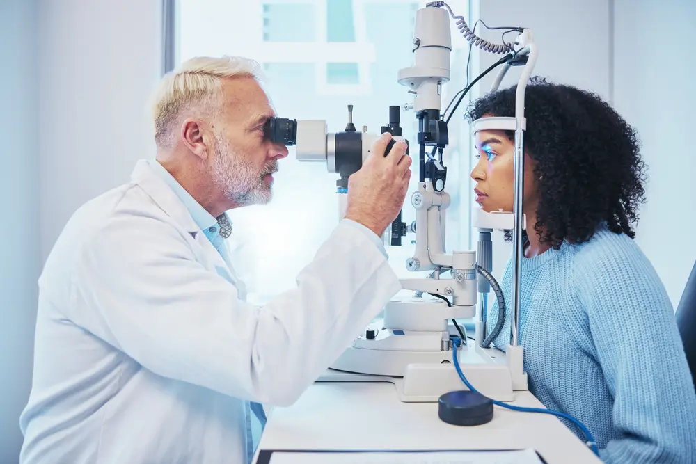 LASIK Surgeon performing an eye exam on a young woman.